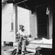 Photo of Bill Tatnall playing guitar on steps